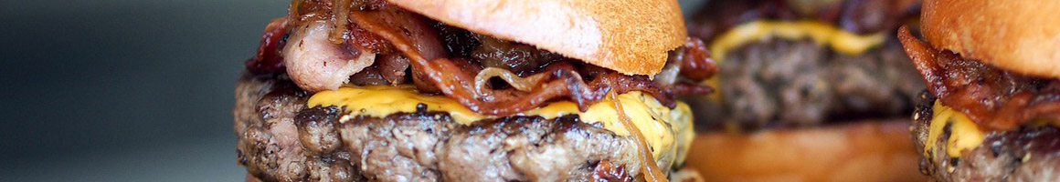 Eating American (Traditional) Burger Hot Dog at Becks Prime restaurant in Houston, TX.